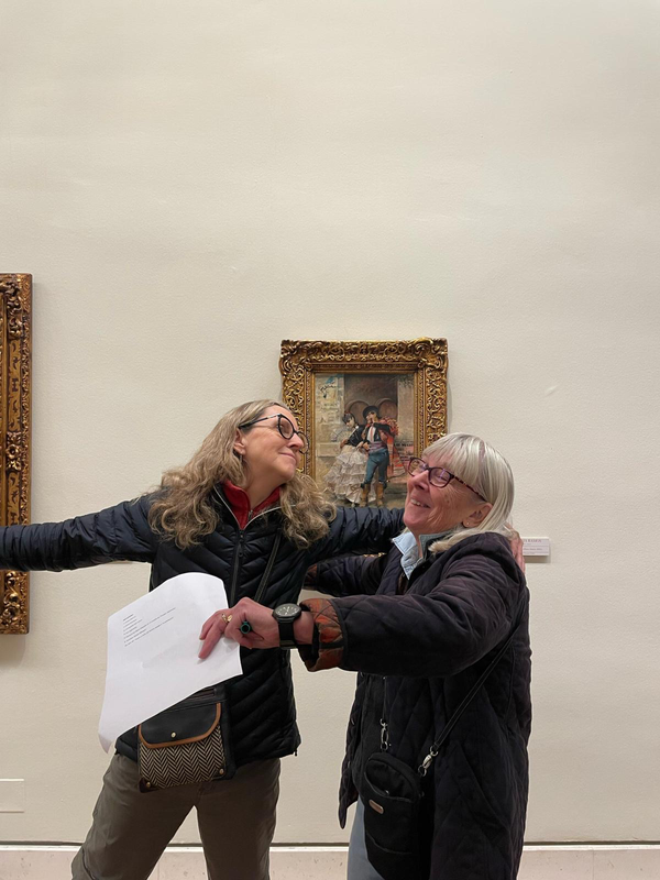 Two senior students enacting scene from painting in the Museum of Fine Arts in Seville