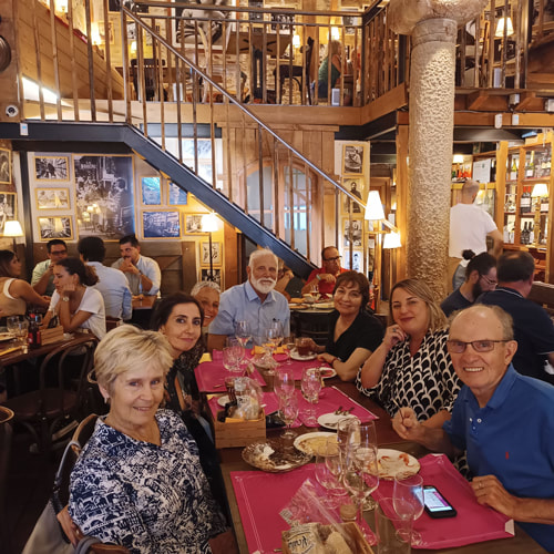 Seniors Spanish abroad group at a dinner in traditional restaurant
